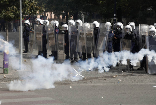 Protesters Clash with Police During a Demonstration in Tirana, Albania. Riot police officers take cover as protester throw back tear gas canisters during an anti-government demonstration in central Tirana on October 15, 2026, as protests continued for a third consecutive day over university conditions and demands for the resignation of Albanian Prime Minister Edi Rama. The latest rally follows two nights of violence in the capital, during which protesters and riot police clashed, police used water cannons and tear gas, and demonstrators damaged government offices and shops and set fire to several buildings. Light Studio Agency Malton Dibra Tirana Albania Copyright: xLightxStudioxAgencyx xMaltonxDibrax