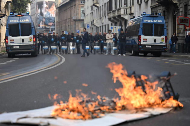 Nationwide school strike in Milan MILAN, ITALY - OCTOBER 16: Police officers look at a banner on fire during a nationwide school strike in Milan, Italy, on October 16, 2026. Protesters oppose the government s education policies and measures they consider discriminatory towards students of foreign origin, also highlighting demands for higher wages and an end to precarious employment in schools. Piero Cruciatti Anadolu Milan Italy. Editorial use only. Please get in touch for any other usage.  Copyright: x2026xAnadoluxPieroxCruciattix