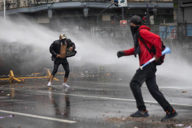 October 16, 2026, Buenos Aires, Buenos Aires, Argentina: Protesters flee water sprayed from police water cannon trucks during clashes with police. Buenos Aires Argentina - ZUMAp265 20261016_zip_p265_048 Copyright: xDelfinaxCorberaxPix