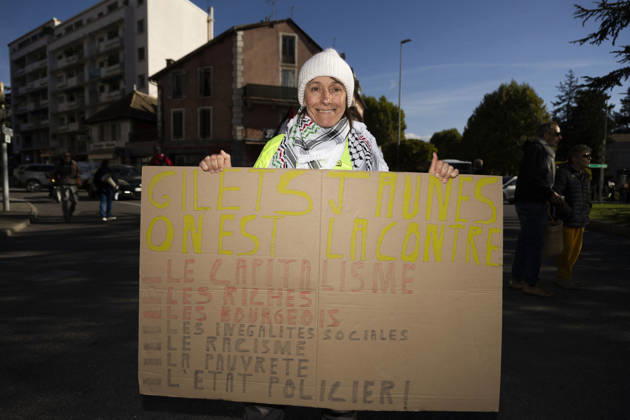 High Cost of Living Protest - Gap A demonstrator in a yellow vest holds a large handwritten placard during the march in Gap, France, on October 17, 2026. Its headline calls for Gilets jaunes to stand against capitalism; the smaller wording is not fully legible. Photo by Thibaut Durand ABACAPRESS.COM Gap Provence-Alpes-Cote d Azur France  Copyright: xDurandxThibaut ABACAx