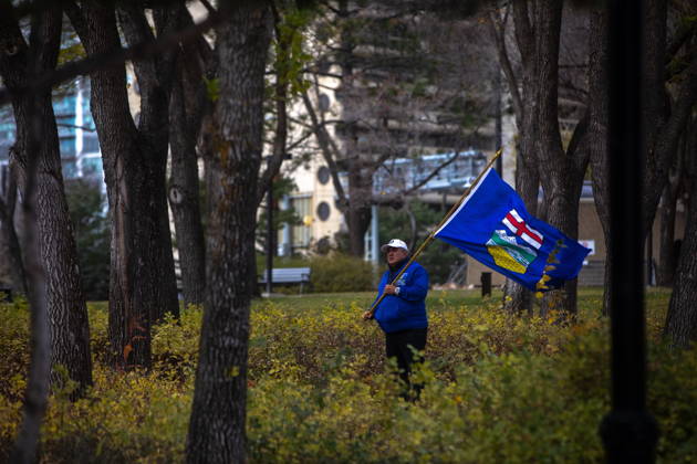 October 17, 2026, Edmonton, Ab, Canada: An attendee stands in the trees during an Alberta independence rally at the Alberta legislature, in Edmonton on Saturday, Oct. 17, 2026. Edmonton Canada  - ZUMAc35_ 20261017_zaf_c35_043 Copyright: xAmandaxMayxEricksonx