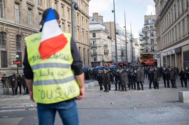 High Cost of Living Protest - Paris AJ A protesters holds a smoke flare and a French national flag during a demonstration to protest against the high cost of living , at Place de la Republique in Paris on October 17, 2026 as part of a nationwide call for mobilisation bringing together various groups expressing their anger: former Yellow Vest , secondary school and university students, climate activists and even farmers. After weeks of student protests, France faces broader, nationwide demonstrations on October 17, 2026 over the cost of living, setting up a potentially fraught six months heading into a presidential election. A police source told AFP that authorities estimated nearly 200,000 people could take part, with 40,000 in Paris. Pho  Copyright: xJumeauxAlexis ABACAx