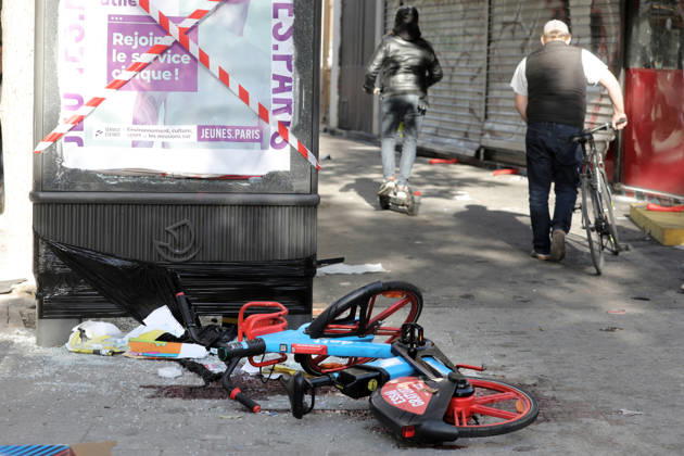 People walk past debris near Republique Square in Paris, on Sunday, October 18, 2026. Residents awoke to scenes of widespread damage with shopfronts shattered, burnt out cars, charred bikes, and piles of glass and debris on the pavements of the French capital a day after riots erupted during protests against rising fuel prices, the cost of living and deteriorating public services, including schools.  PAR20261018107 MAYAxVIDON-WHITE