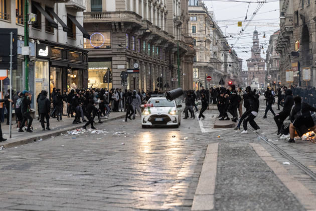 IPA89867555 - Milan, October 18, 2026: More Clashes and Looting in Downtown Milan the Day After the Protest; Pictured: A Local Police Patrol Car Under Attack  Copyright: xFrancescoxEnriquezx xFrancescoxEnriquezx IPA89867555