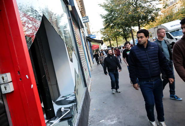 (261018) -- PARIS, Oct. 18, 2026 -- People walk past a shop damaged during a protest in Paris, France, Oct. 18, 2026. French President Emmanuel Macron on Sunday vowed legal action against those responsible for violence during protests across the country on Saturday. ) FRANCE-PARIS-PROTEST-VIOLENCE WuxHuiwo
