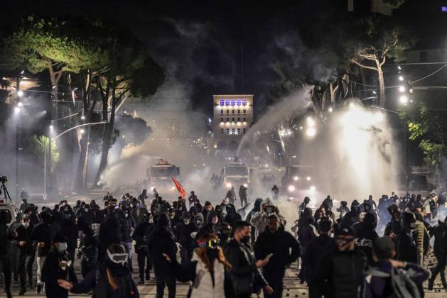 October 18, 2026, Tirana, Albania: TIRANA, ALBANIA, OCTOBER 18, 2026: Demonstrators clash with riot police in Skanderbeg Square as student-led anti-government protests continue for a sixth consecutive day. Confrontations spread from the Ministry of Education to central Tirana, with protesters throwing stones and pyrotechnics while police deploy tear gas and water cannons. Demonstrators demand improved university conditions and the resignation of Prime Minister Edi Rama. Tirana Albania  - ZUMAq101 20261018_zna_q101_222 Copyright: xVlasovxSulajx