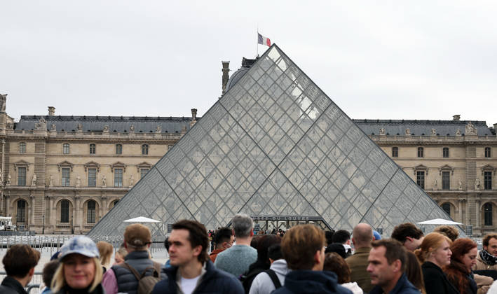 (261019) -- PARIS, Oct. 19, 2026 -- Tourists gather in front of the Louvre Museum in Paris, France, Oct. 19, 2026. In Paris, the entrance to the Louvre Museum was blocked by student protesters on Monday morning, French daily Le Parisien reported, citing the museum s management and two trade unions. According to the trade union General Confederation of Labour, the museum would remain closed at least until noon. ) FRANCE-PARIS-LOUVRE MUSEUM-PROTEST WuxHuiwo 