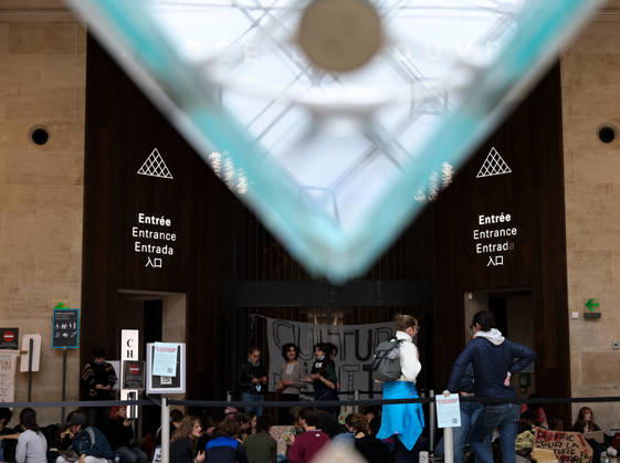 (261019) -- PARIS, Oct. 19, 2026 -- Protesters gather in front of an entrance to the Louvre Museum in Paris, France, Oct. 19, 2026. In Paris, the entrance to the Louvre Museum was blocked by student protesters on Monday morning, French daily Le Parisien reported, citing the museum s management and two trade unions. According to the trade union General Confederation of Labour, the museum would remain closed at least until noon. ) FRANCE-PARIS-LOUVRE MUSEUM-PROTEST WuxHuiwo 