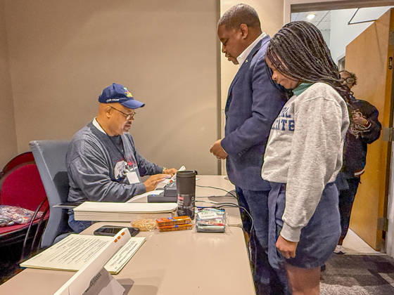 October 19, 2026, Little Rock, Arkansas, USA: Poll worker JERRY SAXTON checks in Democratic Congressional candidate CHRIS JONES so he can cast his ballot on the first day of early vote in Arkansas. Jones is accompanied in line by his daughter, JASMINE JONES. Jones is running for the seat now held by Rep. French Hill (R-AR). Should Jones win, he will be the first Black person Arkansas sends to Congress. Little Rock USA  - ZUMAd155 20261019_znp_d155_027 Copyright: xSuexDorfmanx