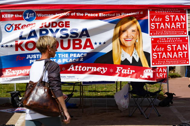A woman walks past campaign advertising during the early voting period at the George Bush center in Houston, Texas, United States, 19 October 2026. Early voting begins in several key states in the United States !ACHTUNG: NUR REDAKTIONELLE NUTZUNG!  Copyright: xCarlosxRamírezx AME7594 20261019-55021730464_1