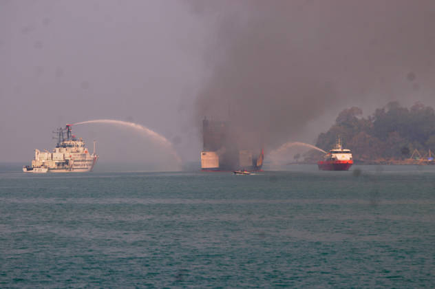 Efforts are underway to extinguish a fire that broke out on a passenger ferry in Indonesia s Cilegon PELABUHAN MERAK, CILEGON, INDONESIA - OCTOBER 21: Fireboats take turns spraying water onto the passenger ferry KMP Batumandi to cool down the vessel after it caught fire while preparing to dock off Merak Port in Cilegon, Banten, Indonesia on Wednesday, October 21, 2026. The vessel caught fire on Tuesday, October 20, and rescue operations remain underway as the ship continues to emit smoke. Water is continuously sprayed to cool the vehicle deck containing numerous cars, motorcycles, buses, and trucks, while authorities confirm no fatalities have been reported. Dasril Roszandi Anadolu Pelabuhan Merak Indonesia. Editorial use only. Please get Copyright: x2026xAnadoluxDasrilxRoszandix