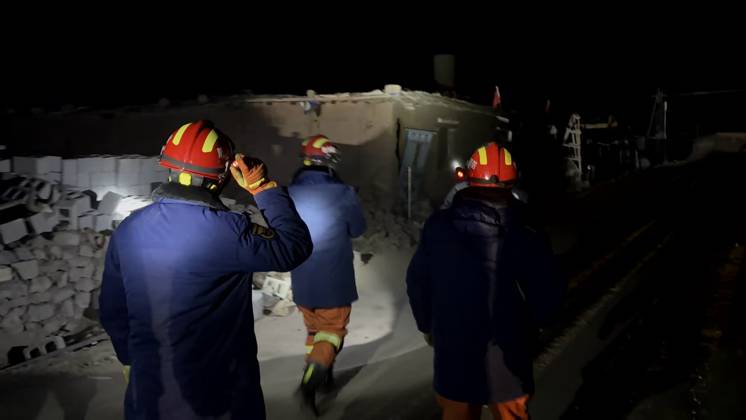 (261023) -- NAGQU, Oct. 23, 2026 -- Firefighters inspect an earthquake-hit village in Baqen County of Nagqu City in southwest China s Xizang Autonomous Region, on Oct. 23, 2026. Sixteen people were killed and 32 others injured after a 7.0-magnitude earthquake struck Baqen County of Nagqu City in southwest China s Xizang Autonomous Region at 10:33 p.m. Thursday (Beijing Time), according to the city s emergency management bureau. As of 2:25 a.m. Friday, 11 of the injured were in serious condition while 21 sustained minor injuries. Over 300 houses collapsed. The damage caused by the quake is being further evaluated, and disaster relief work is underway. More than 300 police officers have been dispatched to the epicenter for relief wor 