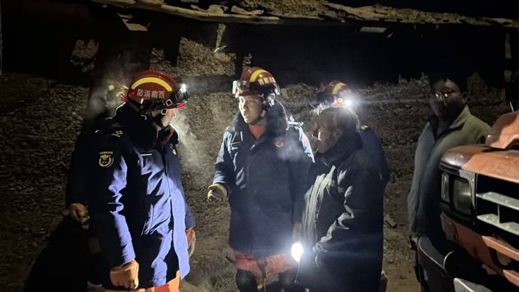 (261023) -- NAGQU, Oct. 23, 2026 -- Firefighters inspect an earthquake-hit village in Baqen County of Nagqu City in southwest China s Xizang Autonomous Region, on Oct. 23, 2026. Sixteen people were killed and 32 others injured after a 7.0-magnitude earthquake struck Baqen County of Nagqu City in southwest China s Xizang Autonomous Region at 10:33 p.m. Thursday (Beijing Time), according to the city s emergency management bureau. As of 2:25 a.m. Friday, 11 of the injured were in serious condition while 21 sustained minor injuries. Over 300 houses collapsed. The damage caused by the quake is being further evaluated, and disaster relief work is underway. More than 300 police officers have been dispatched to the epicenter for relief wor 