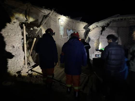 (261023) -- NAGQU, Oct. 23, 2026 -- Firefighters inspect an earthquake-hit village in Baqen County of Nagqu City in southwest China s Xizang Autonomous Region, on Oct. 23, 2026. Sixteen people were killed and 32 others injured after a 7.0-magnitude earthquake struck Baqen County of Nagqu City in southwest China s Xizang Autonomous Region at 10:33 p.m. Thursday (Beijing Time), according to the city s emergency management bureau. As of 2:25 a.m. Friday, 11 of the injured were in serious condition while 21 sustained minor injuries. Over 300 houses collapsed. The damage caused by the quake is being further evaluated, and disaster relief work is underway. More than 300 police officers have been dispatched to the epicenter for relief wor 
