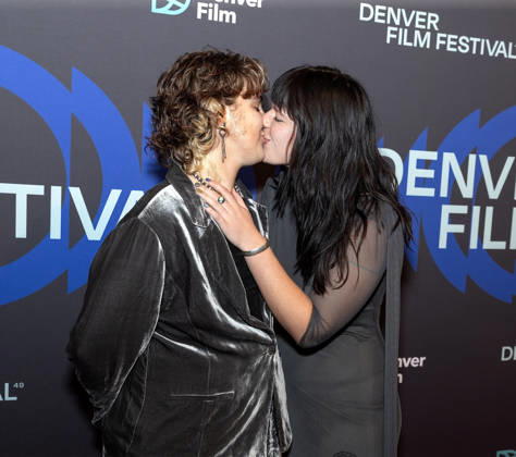 October 23, 2026, Denver, Colorado, USA: Film Subject HAZEL WILTON-GREEN & Director ISABELLA GRACE COHN of the film Watch You Rise kiss while posing for photos during the 49th. Denver Film Festival Red Carpet event at the Ellie Caulkins Opera House Thursday night. Credit Image: ZUMA Press Wire) Denver USA - ZUMAav4_ 20261023_zaf_av4_003 Copyright: xHectorxAcevedox