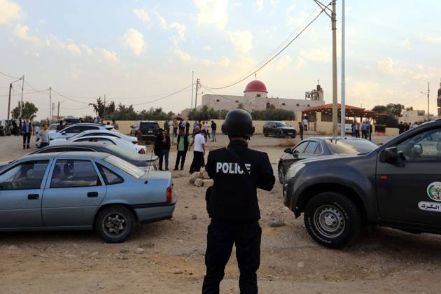 (261023) -- KARAK, Oct. 23, 2026 -- A police officer stands guard outside the church where a shooting attack occurred during a funeral in Jordan s southern governorate of Karak, Jordan, Oct. 23, 2026. Seven people were killed and 34 others injured in a shooting attack during a funeral in Jordan s southern governorate of Karak, the Jordanian Public Security Directorate said Friday. (Photo by Xinhua) JORDAN-KARAK-CHURCH SHOOTING MohammadxAbuxGhosh 