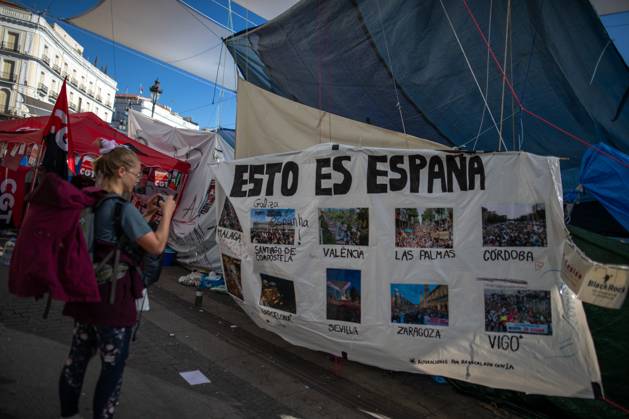October 23, 2026, Madrid, Spain: A banner featuring photographs and the phrase This is Spain can be seen at Puerta del Sol..Tents remain set up by housing rights activists, who organized the occupation of the square in response to the eviction of MaricarmenÃ¢â‚¬a woman in her eightiesÃ¢â‚¬from her home, carried out by a real estate investment fund. Madrid Spain  - ZUMAs197 20261023_aaa_s197_153 Copyright: xDavidxCanalesx
