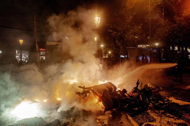 October 24, 2026, Barcelona, Spain: Firefighters extinguish a burning barricade during unrest in central Barcelona. Clashes between demonstrators and police, looting and widespread vandalism were reported across the city centre overnight. Barcelona Spain - ZUMAb137 20261024_fap_b137_002 Copyright: xJordixBoixareux