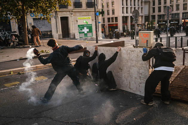 Marseille France Street Protests Protesters take cover behind a wooden barrier while a tear gas canister releases smoke during a protest in Marseille, France on October 24, 2026. Authorities deployed around 70,000 security personnel across France for renewed protests over the cost of living, after unrest a week earlier saw public buildings damaged, hundreds of shops looted and about 2,700 people arrested. Marseille Provence-Alpes-CÃ te France Copyright: xNaelxChahinex