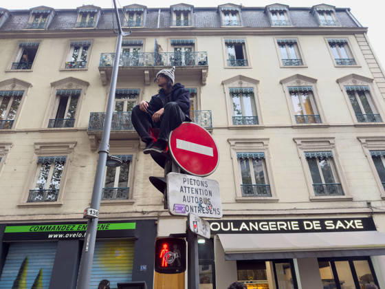 Lyon France Protests October 24 A demonstrator sits atop a traffic signal during a protest in Lyon, France on October 24, 2026. Authorities deployed around 70,000 security personnel across France for renewed protests over the cost of living, after unrest a week earlier saw public buildings damaged, hundreds of shops looted and about 2,700 people arrested. Lyon Rhone Alpes France Copyright: xAbolfazlxSalmanzadehx