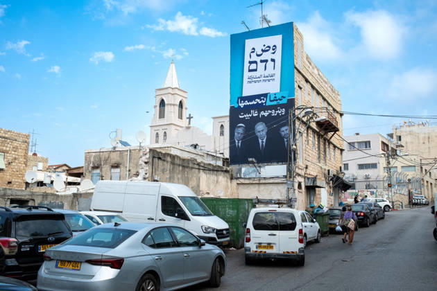 Wahlen in Israel 2026. Israel, Haifa am 24. Oktober, 2026: Riesen Wahlplakat der arabischen Parteienallianz Vereinte Liste , gespannt an eine Hausrücken im überwiegend von arabischen Bürgern bewohnten Stadtteil Wadi Nisnas in Haifa. Der Slogan lautet auf Arabisch sinngemäß: Haifa wird es entscheiden und sie nach Hause schicken. Gemeint sind die Politiker Itamar Ben-Gvir, Benjamin Netanjahu und Bezalel Smotrich, deren Porträts auf dem Plakat in Schwarz-Weiß abgebildet sind.
