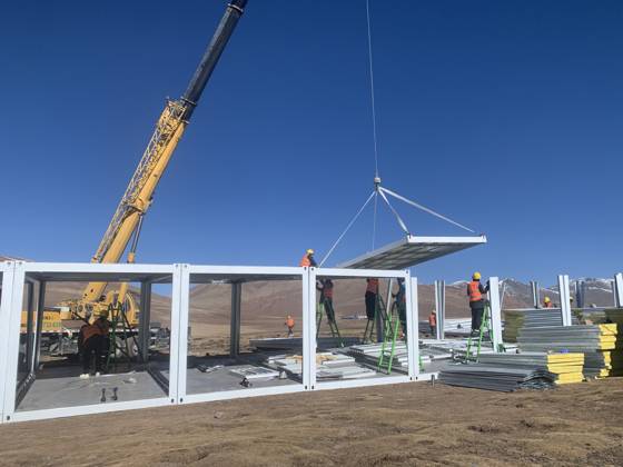 (261025) -- BAQEN, Oct. 25, 2026 () -- Rescuers from the China Railway 20th Bureau Group Corporation Limited build prefabricated houses at a quake-hit village in Gangchen Township of Baqen County, Nagqu City, southwest China s Xizang Autonomous Region, Oct. 25, 2026. Rescue and relief efforts continue after a 7.0-magnitude earthquake struck Baqen County of the city of Nagqu in southwest China s Xizang Autonomous Region, local authorities said Saturday. The roof panels of the first batch of prefabricated houses have been installed in Sunday afternoon in the quake-hit village in Gangchen Township of Baqen, and the laying of cables and the installation of doors and windows have been advanced successively. Currently, seven prefabricated houses 