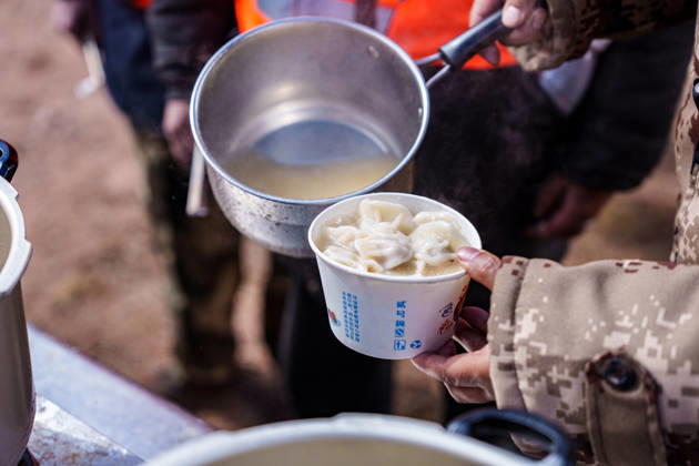 (261025) -- BAQEN, Oct. 25, 2026 -- Du Guoping distributes dumplings to rescuers at a temporary shelter in Maru Township of Baqen County, Nagqu City, southwest China s Xizang Autonomous Region, Oct. 24, 2026. After a 7.0-magnitude earthquake struck Baqen County in Nagqu, southwest China s Xizang Autonomous Region, on Thursday, Du Guoping, owner of a dumpling restaurant in Xigaze, postponed the opening of his two new restaurants and headed to the disaster zone with his staff. It took only about 10 minutes to make the decision that we would go to Baqen and cook dumplings for earthquake-affected residents, Du said. The team loaded more than 1,500 kilograms of dumplings onto vehicles and set off from Xigaze at midnight on the night of th