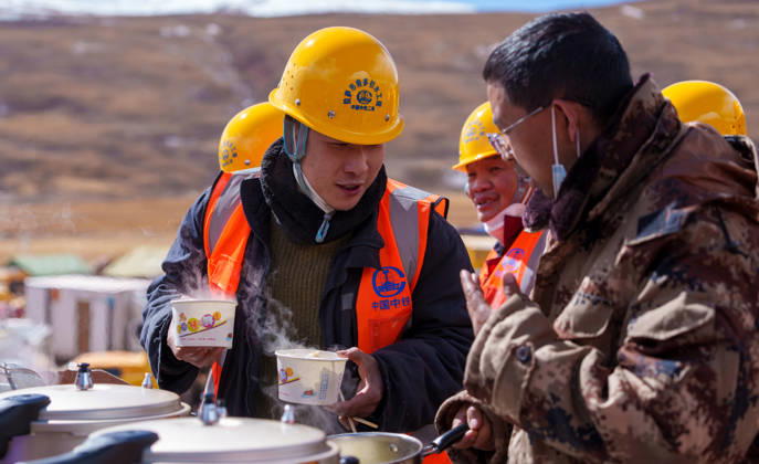 (261025) -- BAQEN, Oct. 25, 2026 -- A rescuer thanks Du Guoping (R) at a temporary shelter in Maru Township of Baqen County, Nagqu City, southwest China s Xizang Autonomous Region, Oct. 24, 2026. After a 7.0-magnitude earthquake struck Baqen County in Nagqu, southwest China s Xizang Autonomous Region, on Thursday, Du Guoping, owner of a dumpling restaurant in Xigaze, postponed the opening of his two new restaurants and headed to the disaster zone with his staff. It took only about 10 minutes to make the decision that we would go to Baqen and cook dumplings for earthquake-affected residents, Du said. The team loaded more than 1,500 kilograms of dumplings onto vehicles and set off from Xigaze at midnight on the night of the earthquake.