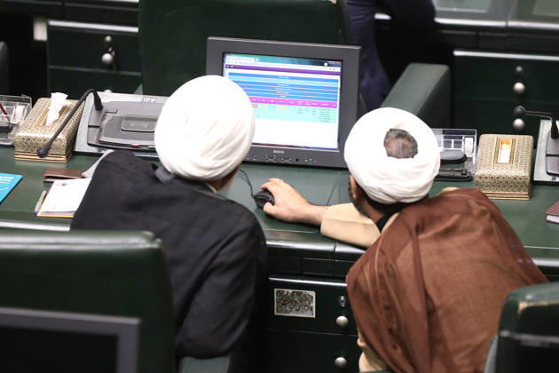 October 25, 2026, Tehran, Iran: Two turbaned clerics lean over an electronic display showing colored rows of information at a parliamentary desk at the Islamic Consultative Assembly in Tehran, Iran, on October 25, 2026. The Iranian parliament held a hybrid open sitting, with some lawmakers attending in the Tehran chamber and others participating remotely, according to parliamentary reports. Tehran Iran - ZUMAi98_ 20261025_zih_i98_112 Copyright: xIcanax